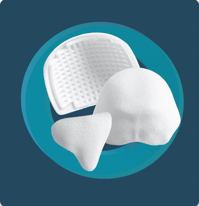 Various white cranial implant shapes showing curved and flat configurations for skull reconstruction
