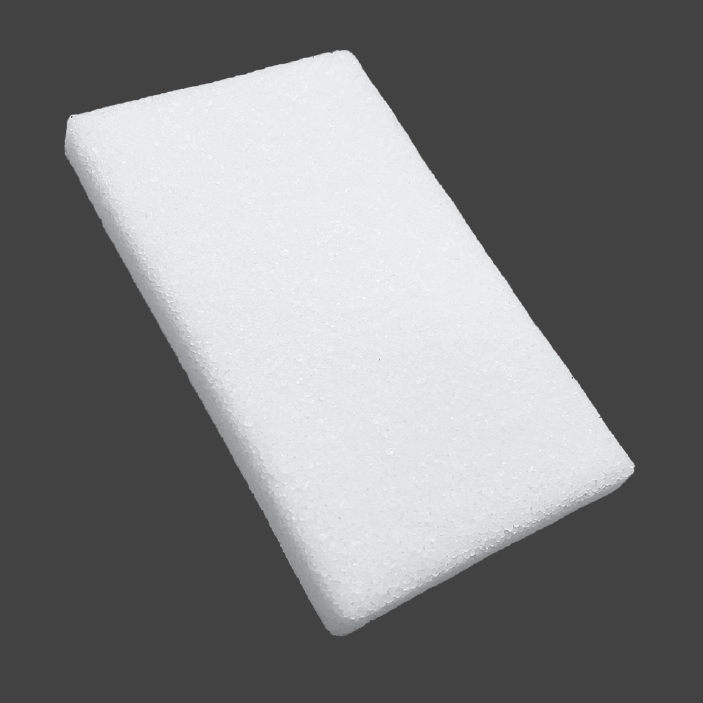 Rectangular white porous polyethylene block implant at an angle